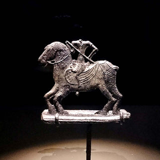 Lead statue of a headless horseman discovered at the ancient site of Forbidden Hill, containing elements typical of Javanese art. Source: National Museum of Singapore.  